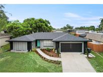 Beautiful single-story home featuring a well-manicured front yard and a spacious two-car garage at 607 Green Briar Blvd, Altamonte Springs, FL 32714