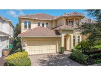 Charming two-story home featuring a tile roof, brick driveway and two car garage at 7398 Gathering Ct, Reunion, FL 34747
