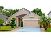 Charming single-Gathering home featuring manicured lawn and a two-car garage at 12406 Beacontree Way, Orlando, FL 32837