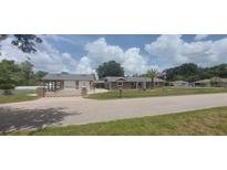 Charming home featuring a private gate entrance and meticulously maintained landscaping at 13785 Se 39Th Ter, Summerfield, FL 34491