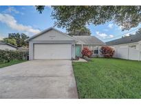 Charming single-story home with a well-maintained lawn and a two-car garage at 1821 Geigel Ave, Orlando, FL 32806