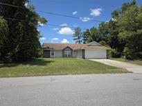 Charming single-story home featuring a brick facade and a two-car garage at 2798 Beckwith St, Deltona, FL 32738