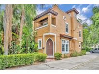 Charming two-story stucco home featuring a distinctive arched doorway and balcony at 337 Cathcart Ave # 6, Orlando, FL 32803
