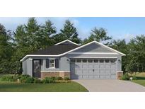 Charming single-Gathering home featuring a gray exterior, brick accents, and a two-car garage at 3751 Bergamot St, Lake Alfred, FL 33850