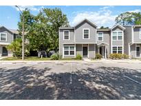 Two-story home featuring gray siding, white trim, and well-maintained landscaping at 4447 Brook Hollow Cir, Winter Springs, FL 32708