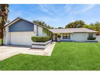 Charming single-story home featuring a well-manicured lawn and neutral tones at 5130 Sun Palm Dr, Windermere, FL 34786