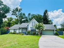 Charming single-Gathering home with a well-manicured lawn, mature trees, and a two-car garage at 660 Neile Ct, Oviedo, FL 32765