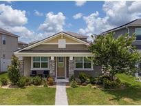Charming single-story home with a welcoming porch and beautifully landscaped front yard at 9115 Longship Aly, Orlando, FL 32832