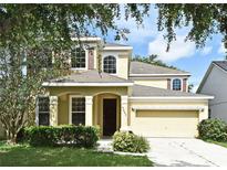 Charming two-story home featuring a well-manicured lawn and attached two car garage at 9223 Leeland Archer Blvd, Orlando, FL 32836