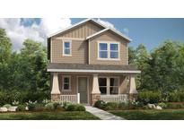 Charming two-story home boasts a welcoming front porch with stone accents and a well-manicured lawn at 12821 Harvest Rain Ave, Winter Garden, FL 34787
