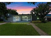 Charming single-story home with well-manicured lawn and inviting front porch at twilight at 1309 W Yale St, Orlando, FL 32804