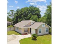 Charming single-story home with a well-maintained lawn and driveway at 145 Lakeside Cir, Sanford, FL 32773
