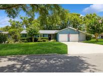 Charming single-story home featuring a two-car garage, well-manicured lawn, and a basketball hoop in the driveway at 1639 Choctaw Trl, Maitland, FL 32751