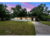 Charming single-story home featuring a well-manicured lawn and cozy front porch area at 206 Gerry Dr, Altamonte Springs, FL 32714