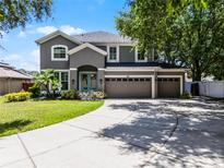 Charming two-story home featuring a spacious three-car garage and a well-manicured front lawn at 207 Via Tuscany Loop, Lake Mary, FL 32746