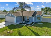 Charming one-story home with a well-manicured lawn, cozy front porch and inviting curb appeal at 3256 Amber St, Deltona, FL 32738