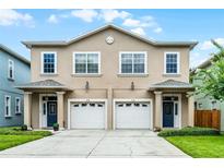 Inviting exterior of a two-story townhome with a neutral color scheme and a two-car garage at 336 E Kaley St, Orlando, FL 32806