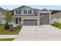 Charming two-story home with three-car garage, landscaped yard and covered entryway at 3990 Bannock Ave, Tavares, FL 32778