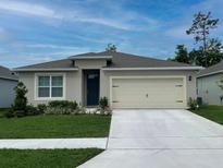 Charming single-story home with a well-manicured lawn, two car garage, and neutral exterior paint at 5147 Marshelder St, Apopka, FL 32712