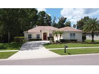Charming single-story home with a well-manicured lawn and a welcoming driveway at 1679 Shadowmoss Cir, Lake Mary, FL 32746