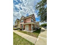 Charming townhome featuring a covered front porch and well-maintained landscaping at 2200 San Vittorino Cir # 102, Kissimmee, FL 34741