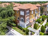Charming townhome with a tile roof, colorful accents, and meticulously landscaped greenery at 4244 Messina Dr, Lake Mary, FL 32746
