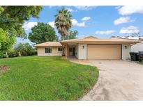 Charming single-story home featuring a two-car garage, mature landscaping, and a classic tiled roof at 5237 Gateway Ave, Orlando, FL 32821