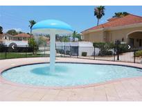 Community pool features a fun mushroom water feature and a view of the community at 667 Bay Leaf Dr, Kissimmee, FL 34759