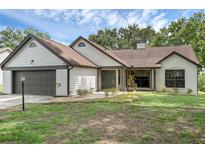 Charming single-story home with neutral paint, manicured lawn, and attached two-car garage at 762 Lake Como Dr, Lake Mary, FL 32746