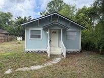 Charming single-story home with light blue siding, a white front door, and a small front porch at 16320 3Rd St, Umatilla, FL 32784