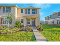 Inviting townhome with manicured lawn and charming front porch, perfect for enjoying the outdoors at 1785 Red Canyon Dr, Kissimmee, FL 34744