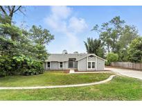 Charming single-story home with a well-manicured lawn and inviting curb appeal at 1850 North St, Longwood, FL 32750