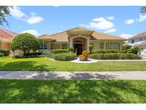 Charming single-story home with a beautifully landscaped front yard and a classic red tile roof at 2256 Kettle Dr, Orlando, FL 32835