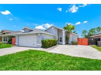 Charming single-story home featuring a well-maintained yard and inviting entrance, located in a quiet neighborhood at 235 Hidden Springs Cir, Kissimmee, FL 34743