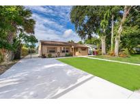 Charming single-story home featuring a well-manicured lawn and a long driveway at 2918 E Central Blvd, Orlando, FL 32803