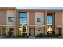 Modern townhome exterior featuring a contemporary design and large windows at 3056 Rockefeller Way, Kissimmee, FL 34747