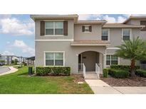 Charming townhome with a well-manicured lawn and inviting front entrance, perfect for a growing Gathering at 4974 Windermere Ave, Kissimmee, FL 34746