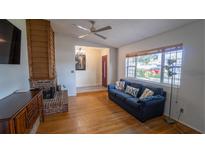 Inviting living room with a fireplace, hardwood floors, and a comfortable blue sofa at 901 Candle Berry Rd, Orlando, FL 32825