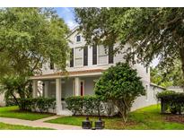 Charming two-story home with a welcoming front porch and well-manicured landscaping at 10117 Sweetleaf St, Orlando, FL 32827