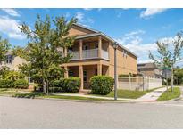 Charming two-story home features a balcony, well-maintained landscaping, and a welcoming facade at 12255 Joshua Tree Trl, Windermere, FL 34786