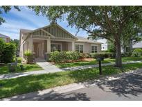 Charming single-story home featuring stone accents, well-maintained landscaping, and a welcoming front porch at 12884 Penshurst Ln, Windermere, FL 34786