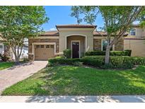 Charming home with a stone facade, manicured lawn, and inviting entrance at 1442 Moon Valley Dr, Davenport, FL 33896