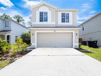 Charming two-story home with a two-car garage, well-manicured lawn, and ample curb appeal at 2006 Stone Abbey Blvd, Orlando, FL 32828
