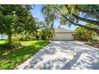 Charming single-story home with a well-manicured lawn, mature trees, and a two-car garage, perfect for suburban living at 2905 Elbert Way, Kissimmee, FL 34758