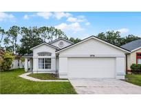 Charming single-Gathering home featuring a well-maintained lawn, two-car garage, and inviting front entrance at 2978 Stillwater Dr, Kissimmee, FL 34743