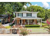 Charming two-story home with a welcoming front porch, brick accents, and a lovely landscaped yard at 3 W Yale St, Orlando, FL 32804