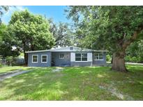 Charming single-story home with a well-maintained lawn, mature trees, and inviting curb appeal at 3501 Amigos Ave, Orlando, FL 32808