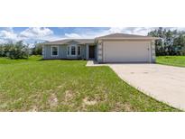 Charming single-story home with well-manicured lawn and attached two-car garage at 428 Danube Way, Kissimmee, FL 34759