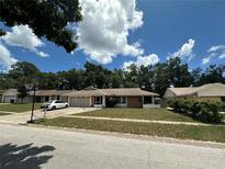 Charming single-story home featuring a well-kept lawn, attached garage, and a basketball hoop in the driveway at 448 S Meander Dr, Altamonte Springs, FL 32714