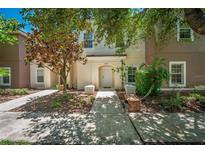 Inviting townhome exterior with a well-manicured lawn and covered entrance, creating great curb appeal at 4558 Baleno Ln, Kissimmee, FL 34746